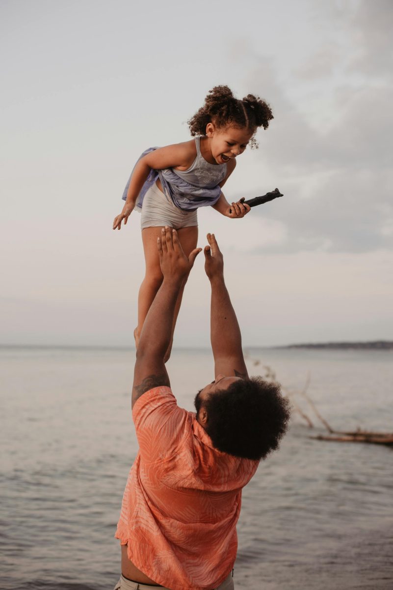 Father And Child Having Fun on the Beach